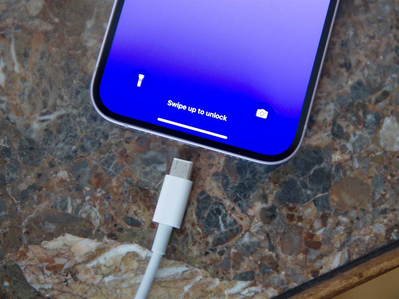 An iPhone 14 Plus and USB-C cable.