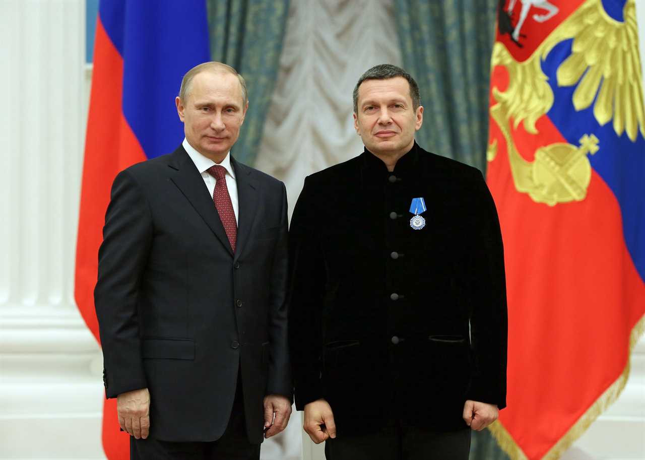 Russian President Vladimir Putin, left, and Russian television and radio host Vladimir Solovyov pose for a photo during an awards ceremony in Moscow's Kremlin on Dec. 25, 2013.