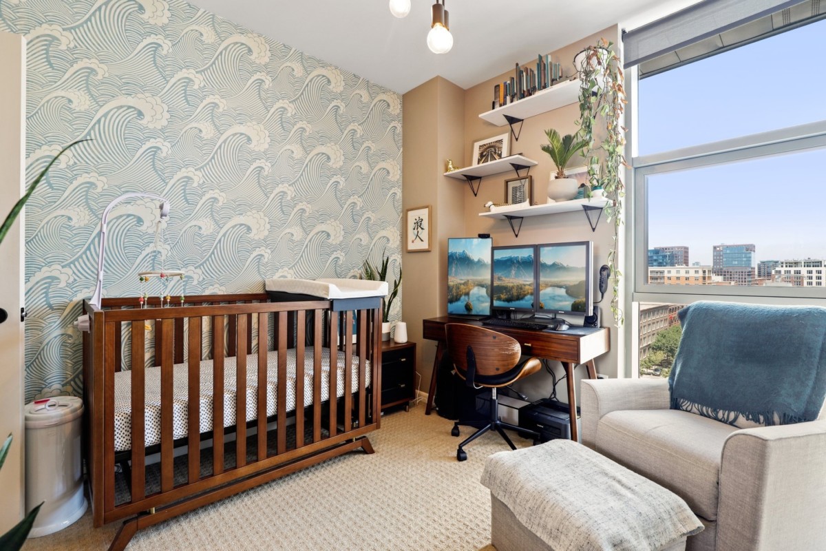 multi-functional office attic with wallpaper and lots of decor