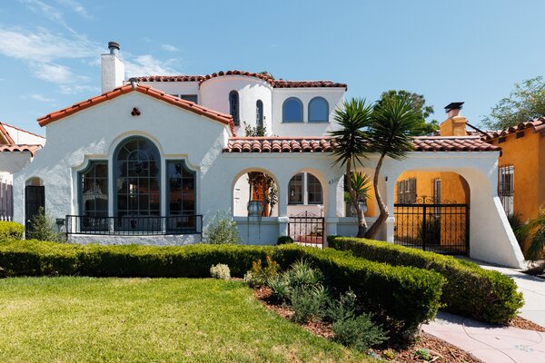 Upon arrival, a generous-sized courtyard leads to the main entrance, as well as the private backyard which is peppered with avocado trees.