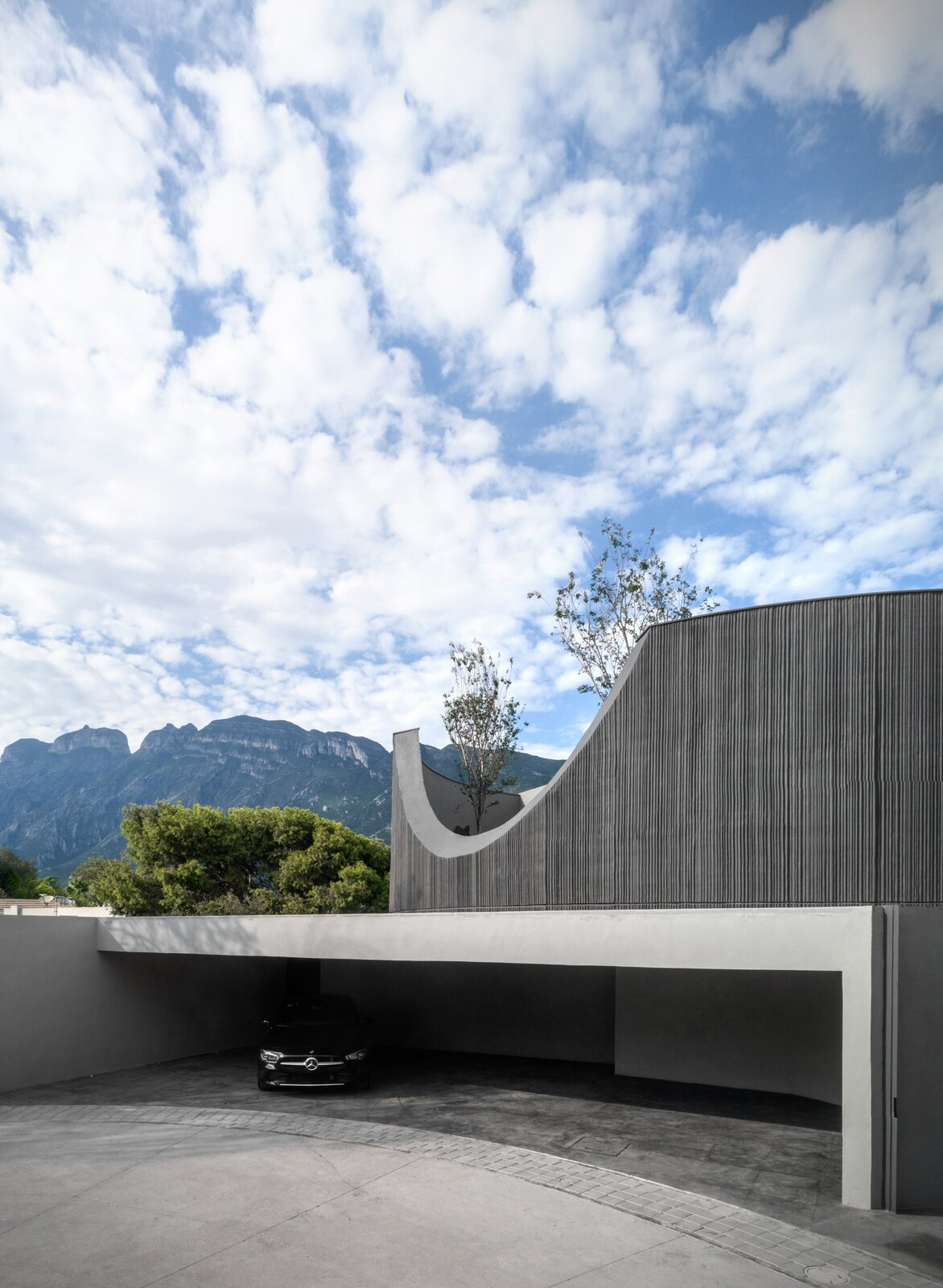 The garage of Casa del Tec leads into the second level of the home. The patio on the third level can be seen through the cutout.