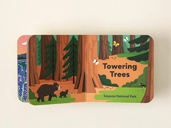 kids book opened to a page with bears and "towering trees" text