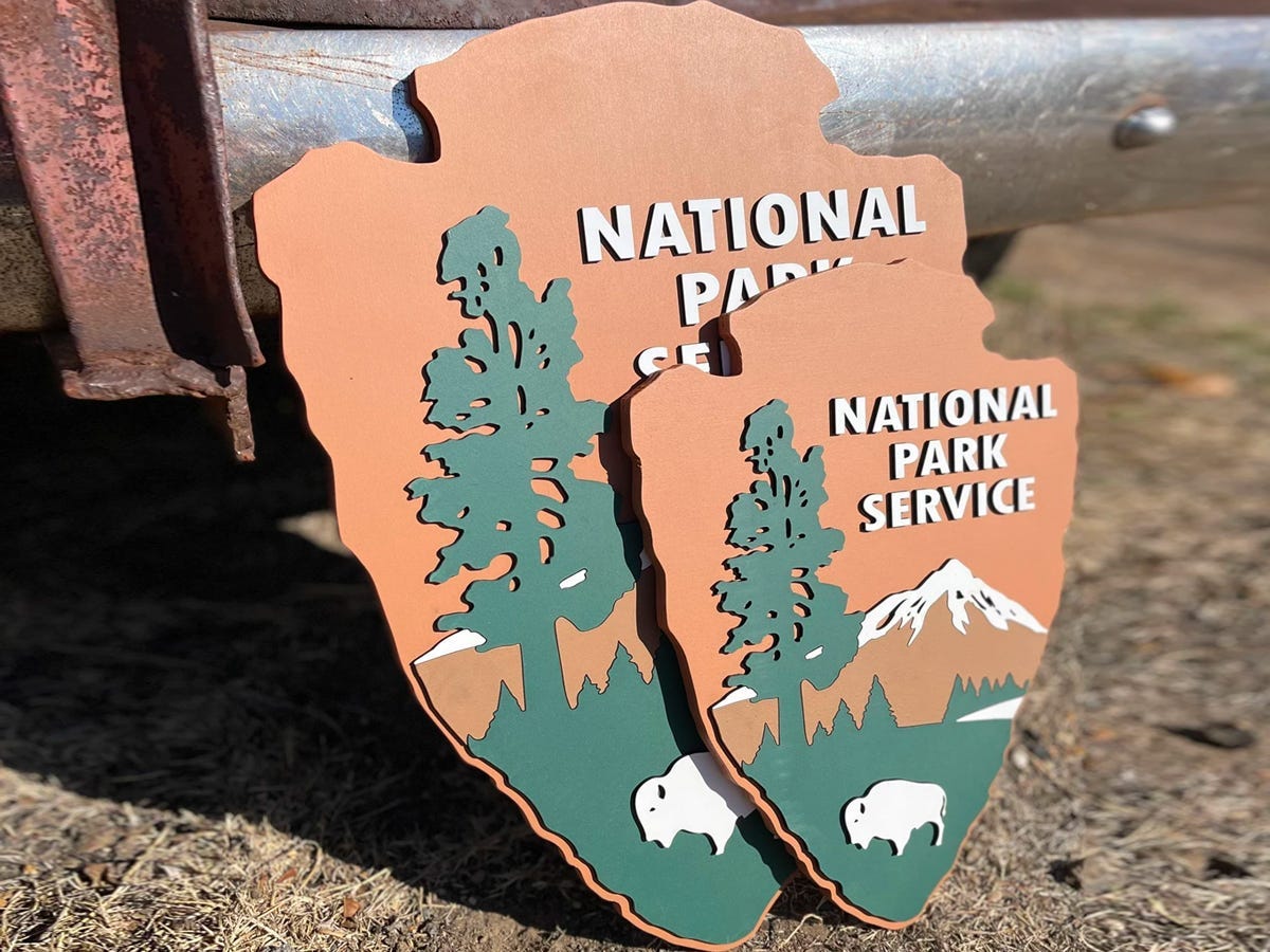 National Park Service Signs leaning up against metal