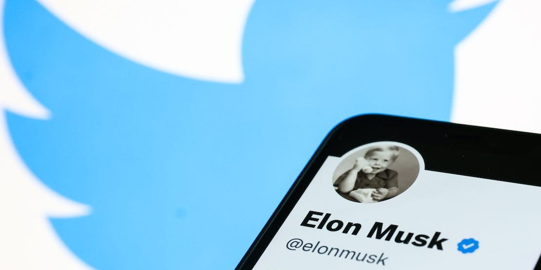 Twitter logo with iPhone showing Elon Musk's Twitter profile.