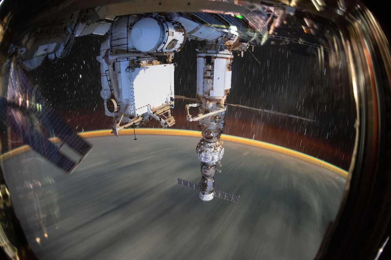 space station window view shows long time lapse earth streaking below