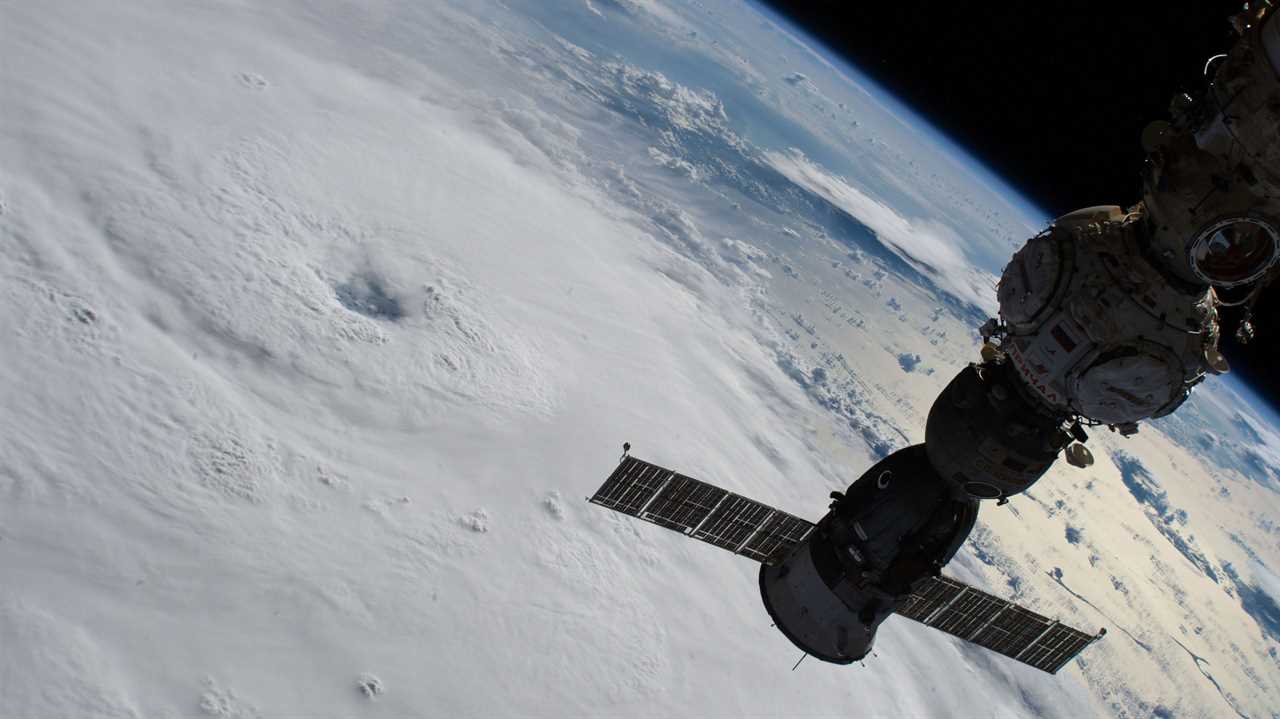 space station module above hurricane on earth below