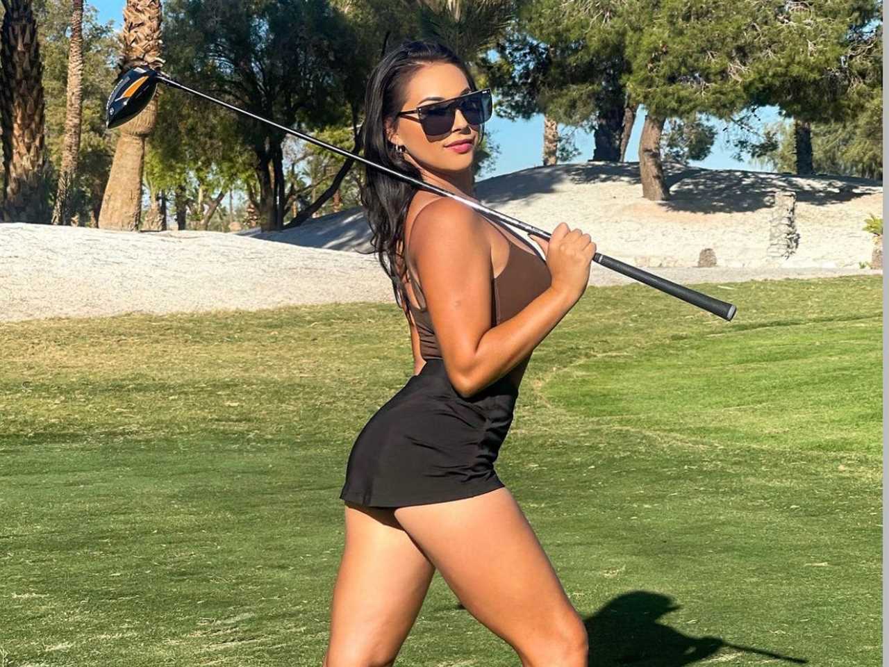 woman holding a golf club