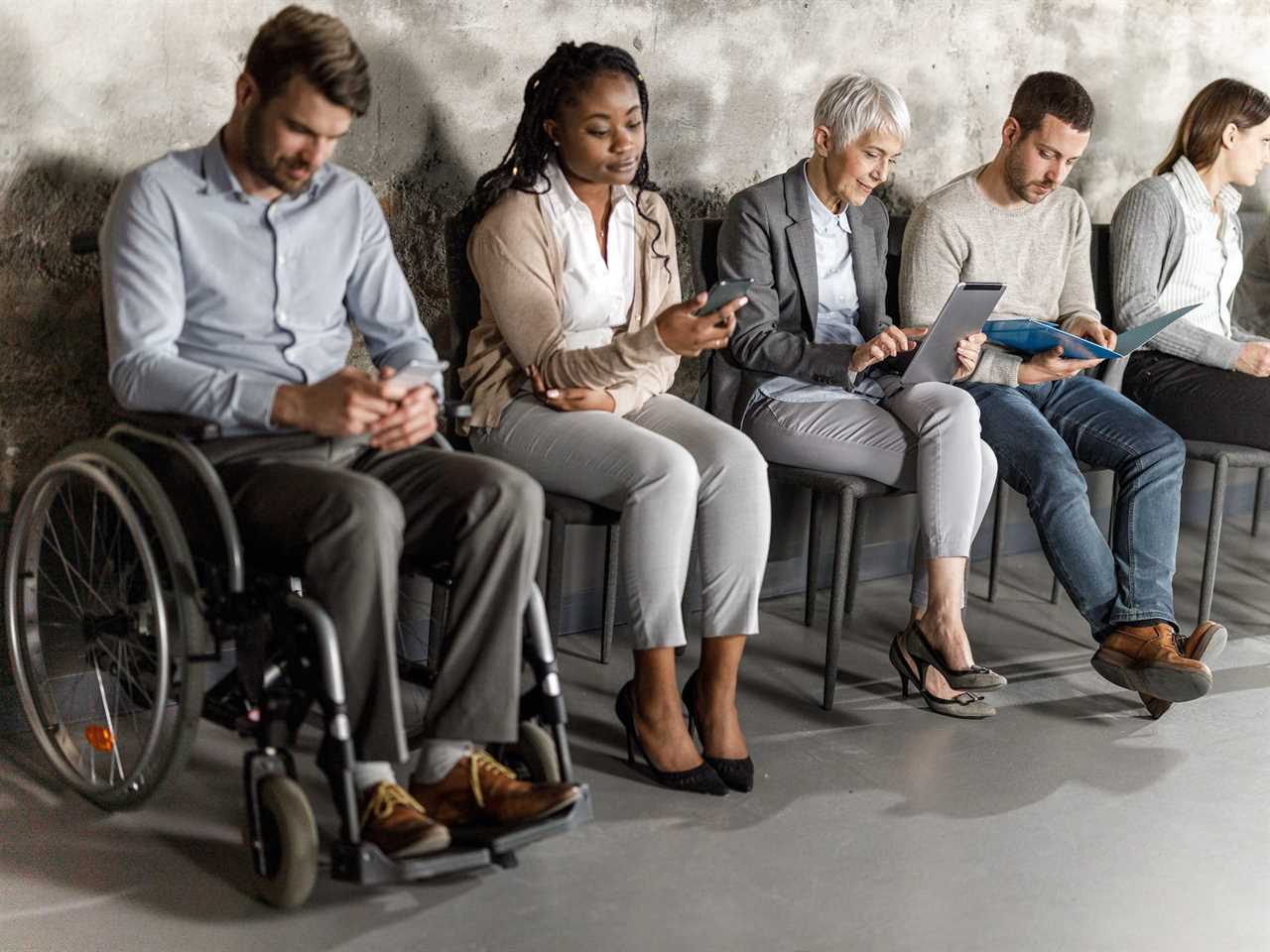 Six job seekers anticipating job interview in waiting room