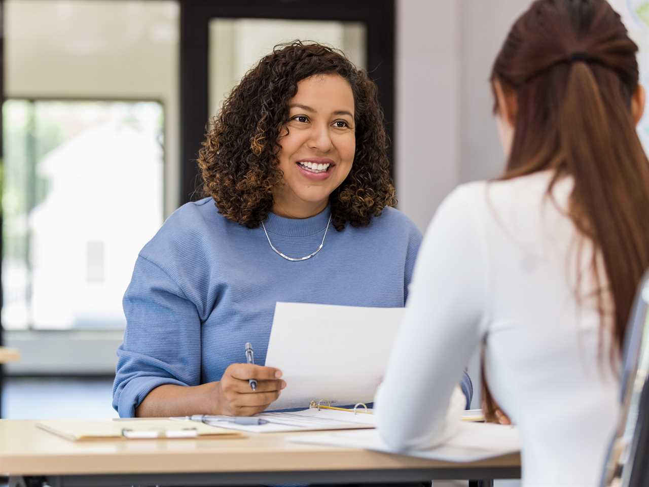 Hiring manager job interview holds resume