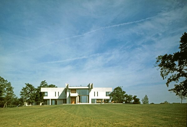 Hill House was designed by Denys Lasdun for Timothy Sainsbury as a country house and the home of much of his distinguished collection of art. The house stands atop a gentle hill in Arcadian countryside, and Lasdun and his client spent time considering and discussing the siting of the house to maximise the pleasure of the views, which are carefully framed by the house's windows.The materials of the house are dominated by concrete: near-white 'forticrete' blockwork and board-marked in situ, which Lasdun was using at the same time on the National Theatre. This tough palette caused local rumours that a new school or military facility was being built, but in fact the generous spaces and beautiful craft quality of the construction make the interiors more reminiscent of the stone halls of ancient aristocracies than of post-war institutional architecture.Later additions track Lasdun's fascinating 1980s-90s stylistic development, with hints of Mackintosh and post-modernism.