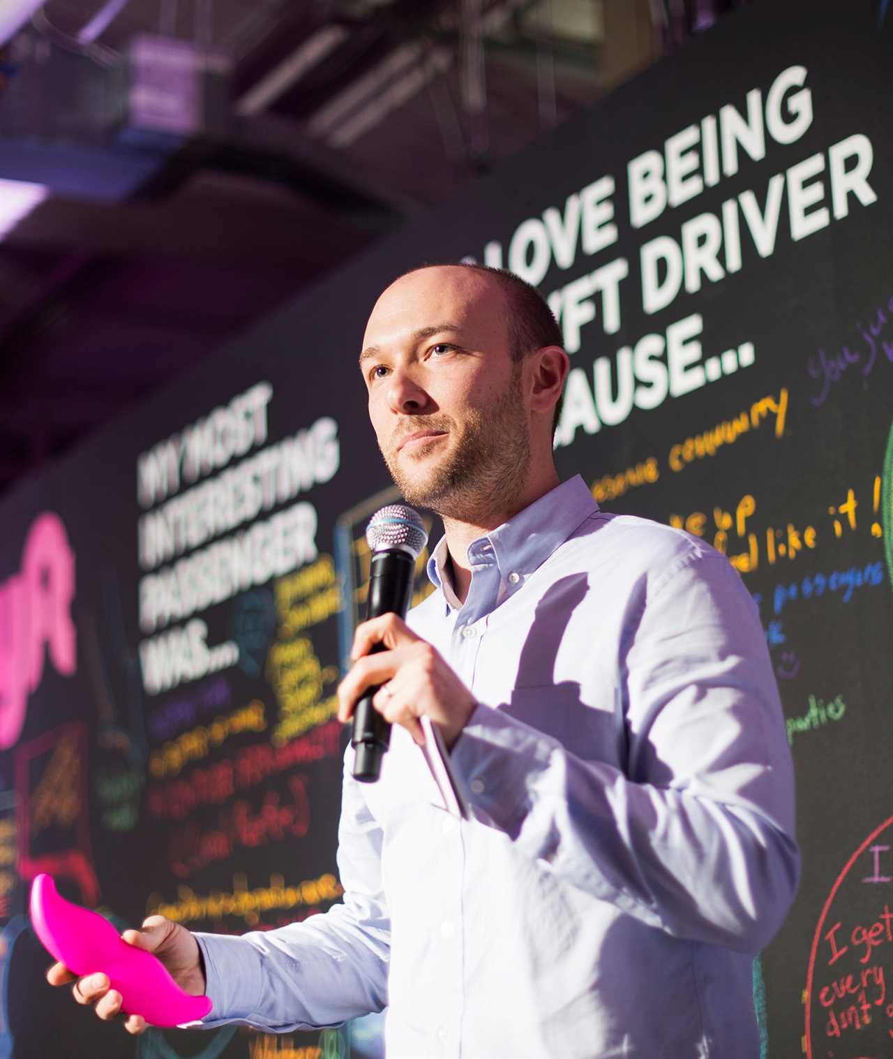 Logan Green, Lyft cofounder and CEO, speaking into microphone