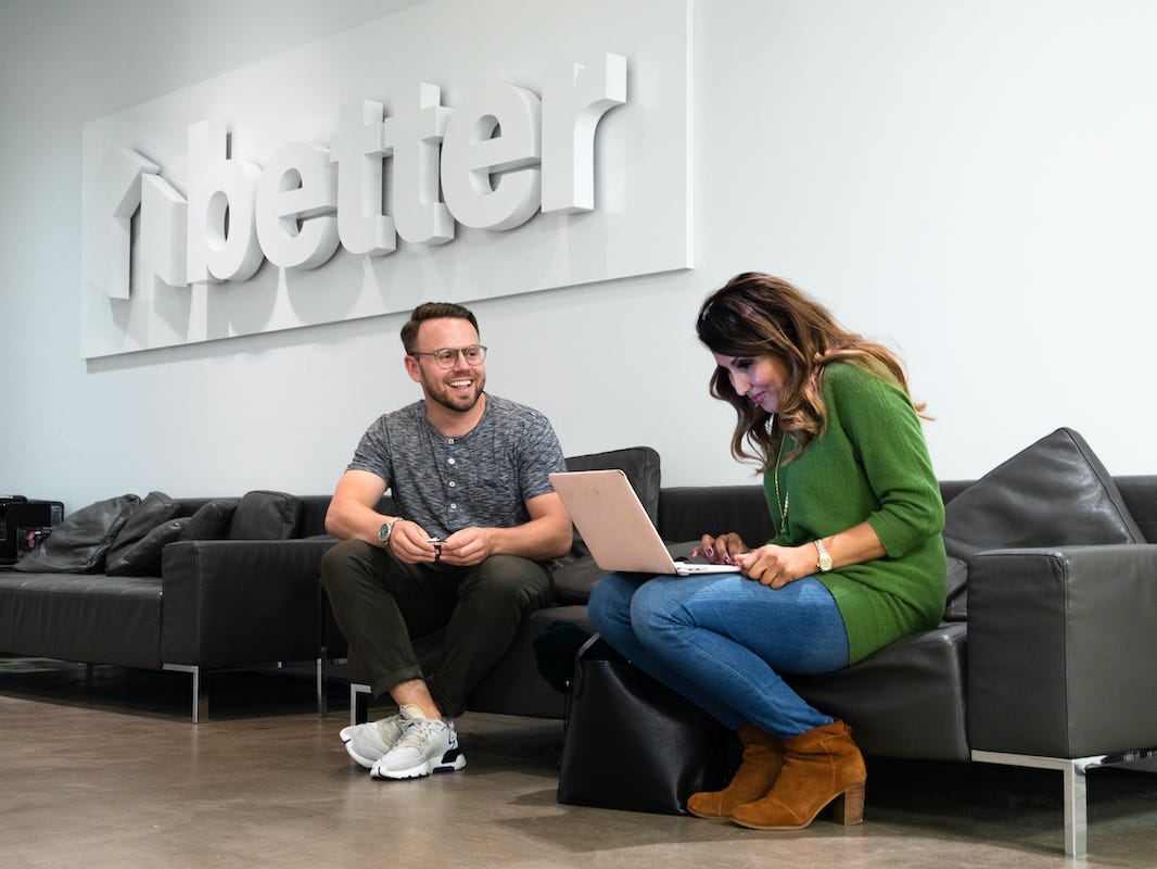 Better employees, a man and woman sitting on a couch, one with a laptop in her lap, pose for a photo at the headquarters in New York City.