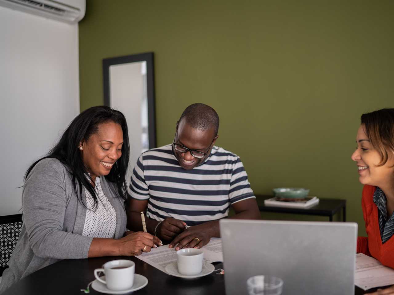 A couple signing mortgage documents.