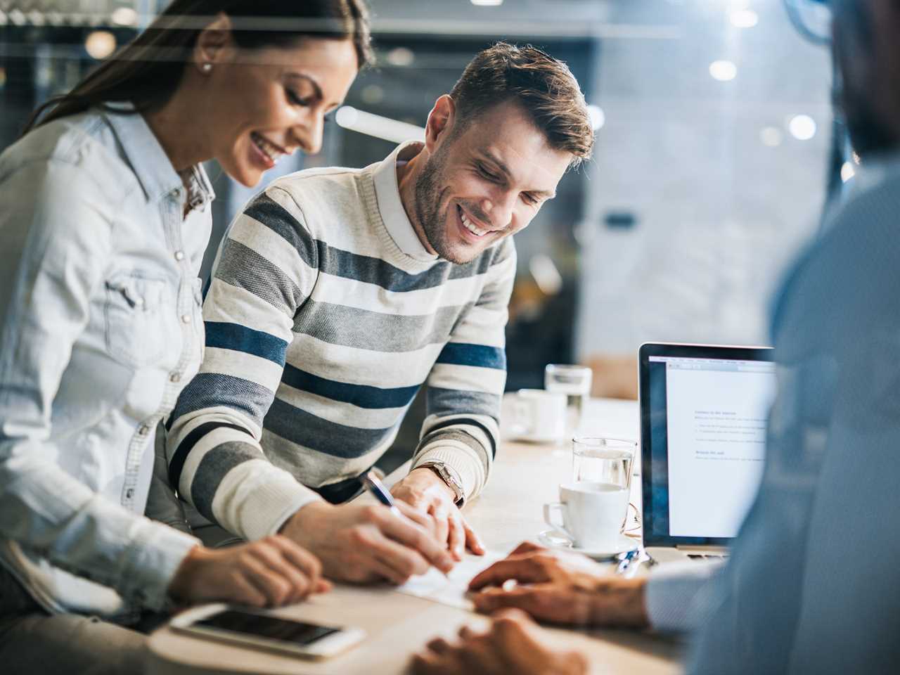 A couple signing a mortgage document.