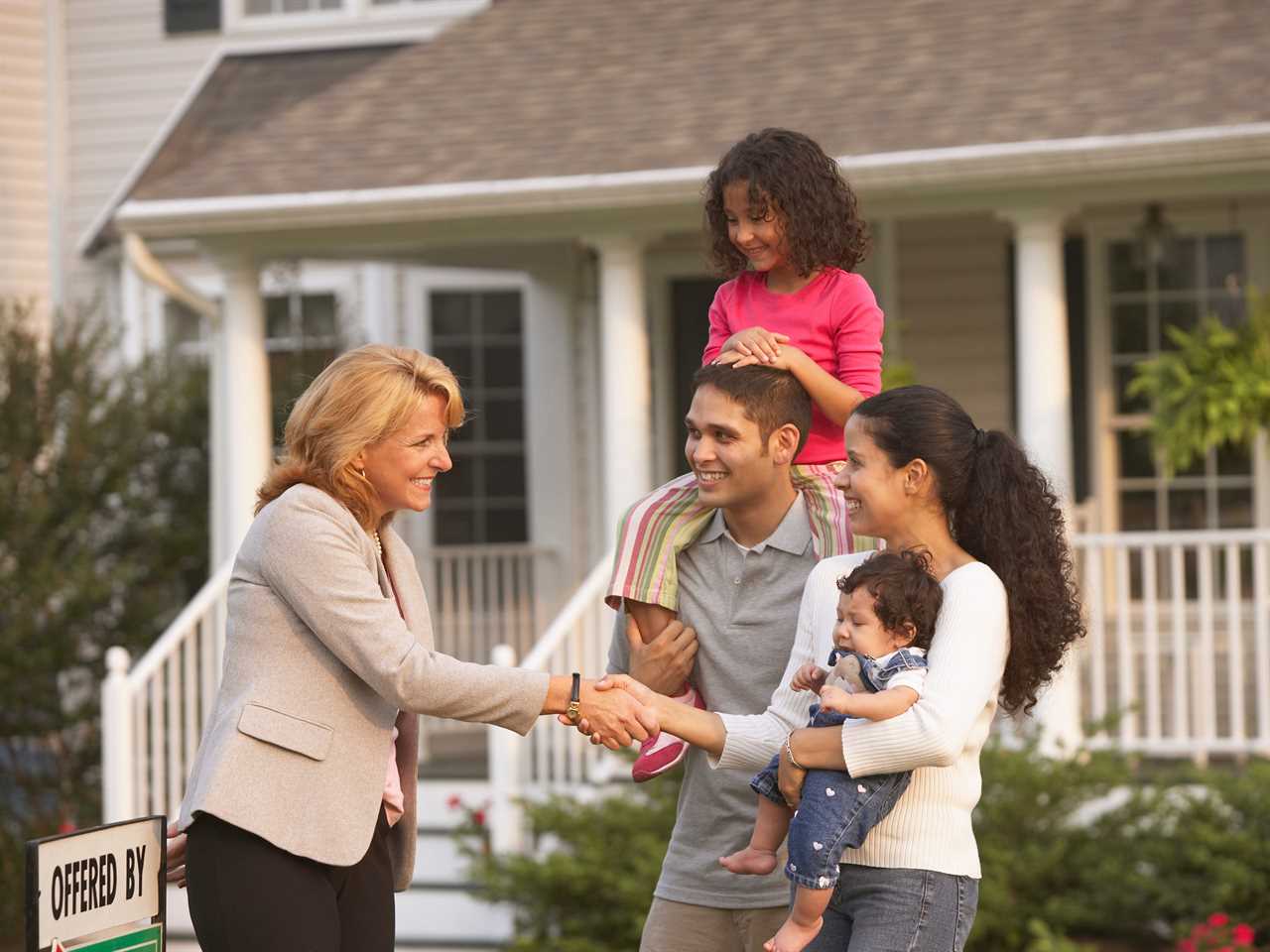 A family talking to a real estate agent.