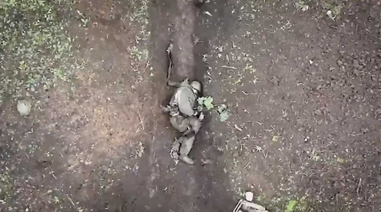 A screenshot from a video showing grenades being dropped on a Russian soldier.