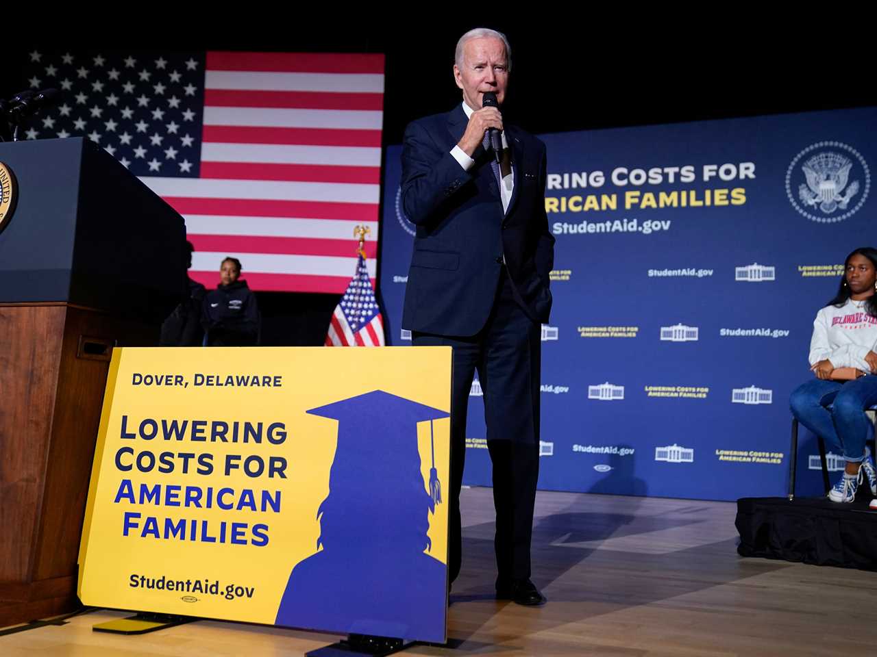 Joe Biden holding mic on stage