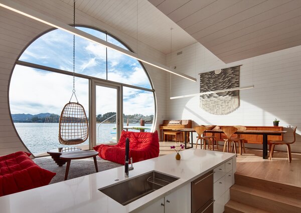 In Hanna Bui’s Sausalito houseboat, designed by architect Craig Steely, sea creatures seen through an enormous back window animate bay views. Walls of plank siding dry out easily if they get damp, and different levels of bleached oak floors demarcate living areas and a sunken kitchen. Red Line Roset Togo sofas are paired with a suspended bamboo seat.