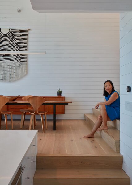 Hanna commissioned the Julia Canright tapestry hanging above a midcentury credenza. Cherner dining chairs are paired with a custom steel table with a live-edge acacia wood top from Ponderosa Millworks.