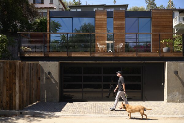 The light-gauge steel structure sits on top of a garage