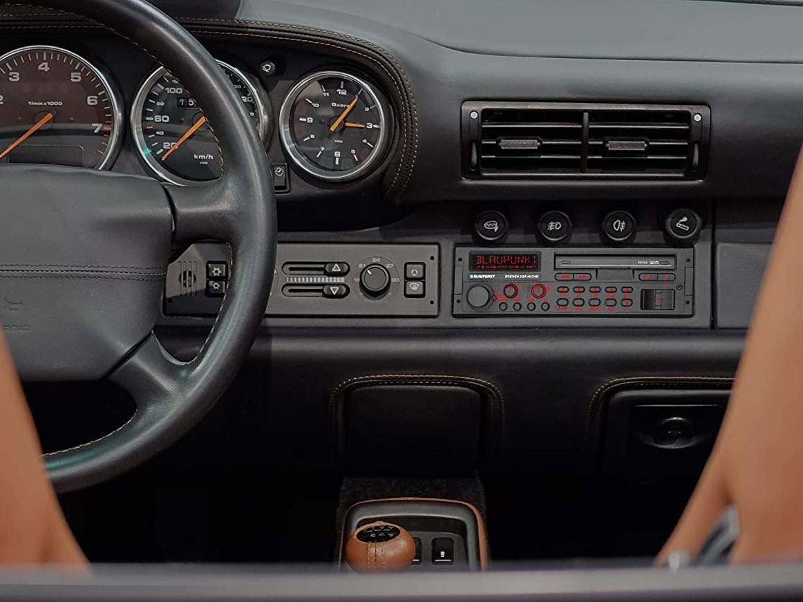 point of view of someone looking at the radio in their dashboard in a car