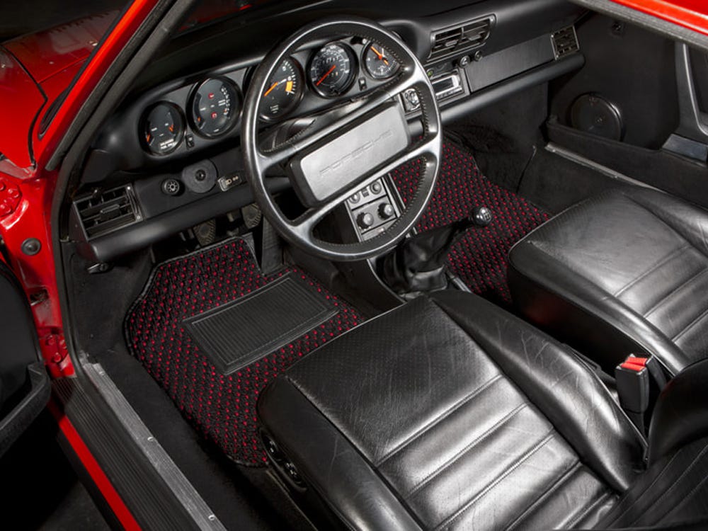 The interior of a car with Coco Mats on the floor of the driver's and passenger's seat.