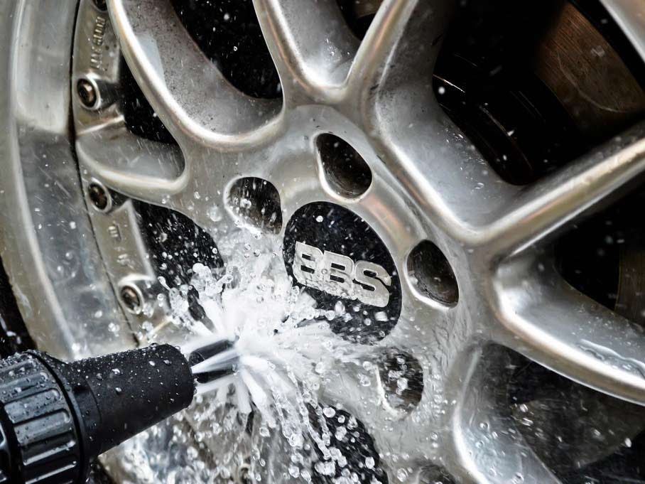 The Brush Hero scrubbing the wheel of a tire.