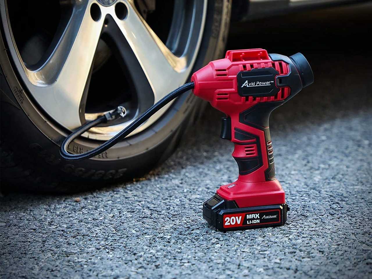 The Avid Power Cordless Air Compressor attached to a car tire.