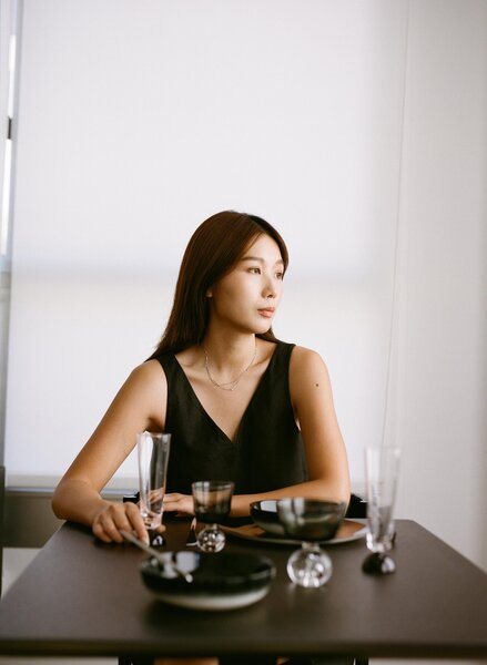 Designer Jialun Xiong sits at her pared-down, intentional, table for two.