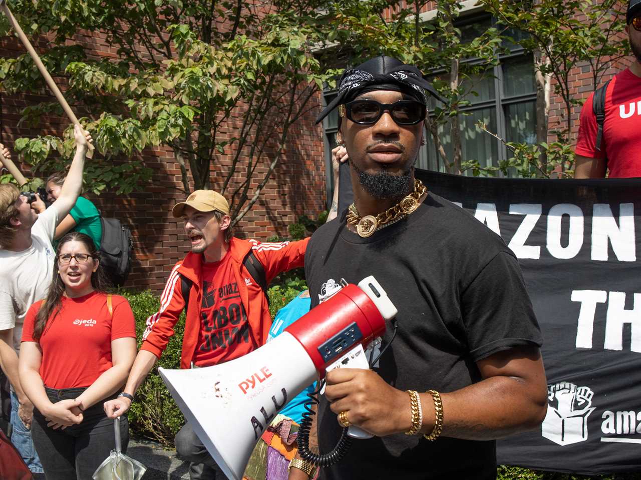 Chris Smalls stands in front of a union banner with a megaphone