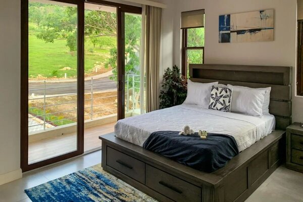 One of the trio of bedrooms features a private balcony for soaking up the views.