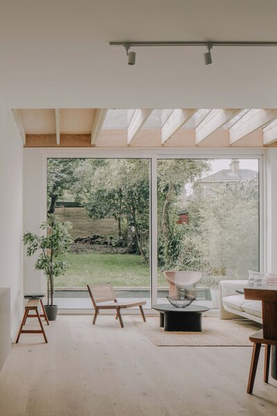 Upon entry, a long hallway leads to the home's main living areas, all of which are designed with a soft, neutral palette to maximize natural light.