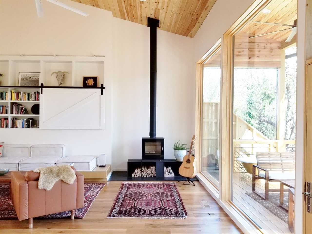 An energy-efficient, Danish wood-burning stove by Rais anchors one corner of the living room. 