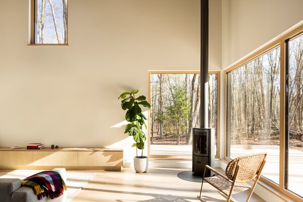 The southwest-facing corner with the wood stove and the forest views is the spot in the home Emilie loves best. 