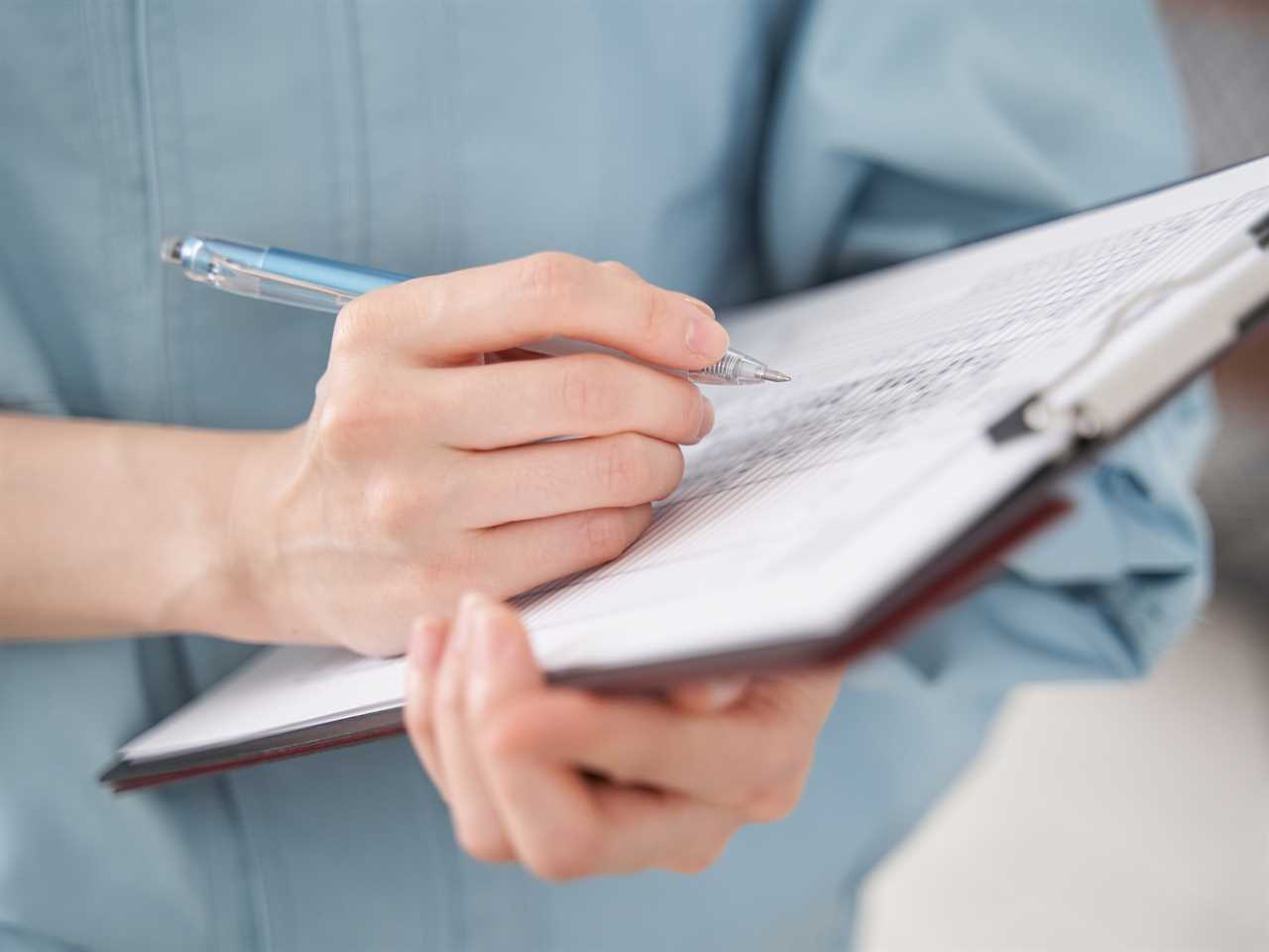 A stock image shows someone conducting a home appraisal