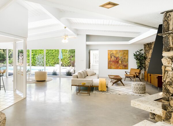 Inside, polished concrete floors run throughout, connecting the expansive living room and dining area. The remodeled kitchen is cleverly situated in the center, open-air atrium.