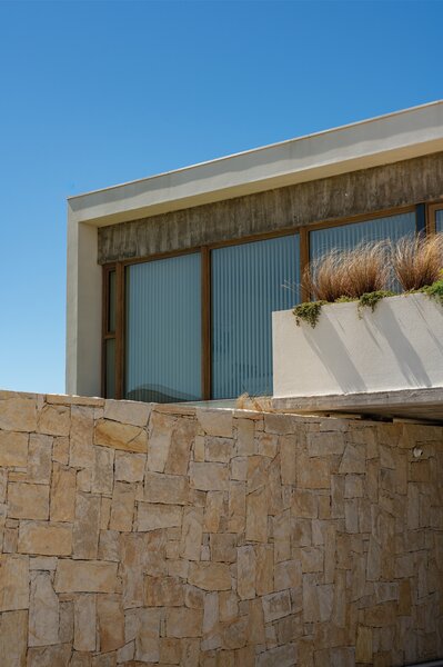 A Concrete Home on the Coast of Argentina Uses Stone to Connect Land and Sea