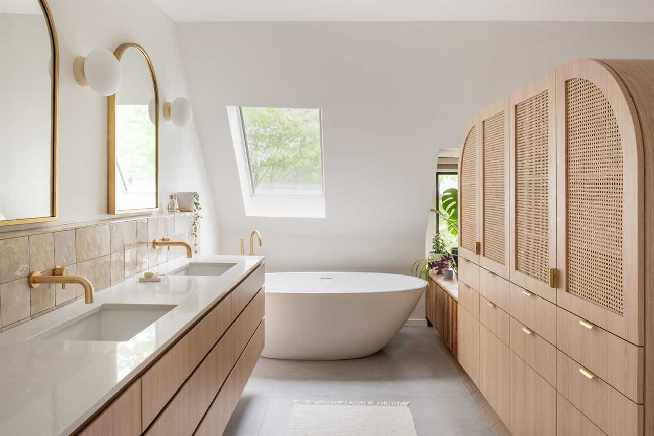 The former closet was transformed by opening up the wall to the bedroom and adding a skylight above the bathtub. The light timber joinery and bright white surfaces enhance the feeling of light.