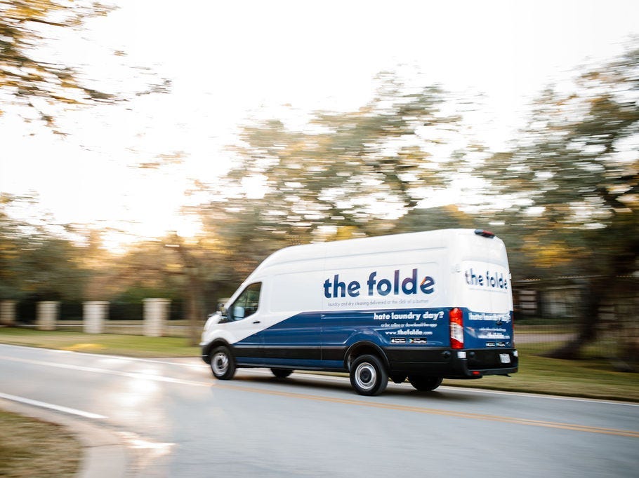 a white van with The Folde logo drives down the street