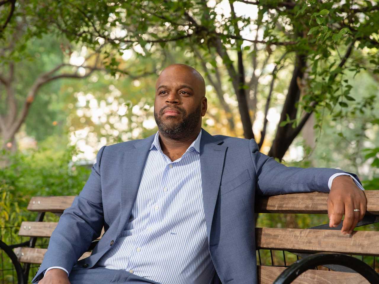 Nolan Townsend sitting on a bench in a park.