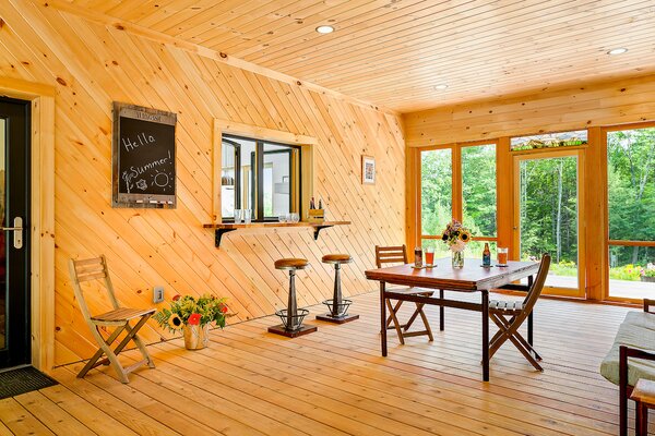 The wood-paneled breezeway serves as a classic Maine 