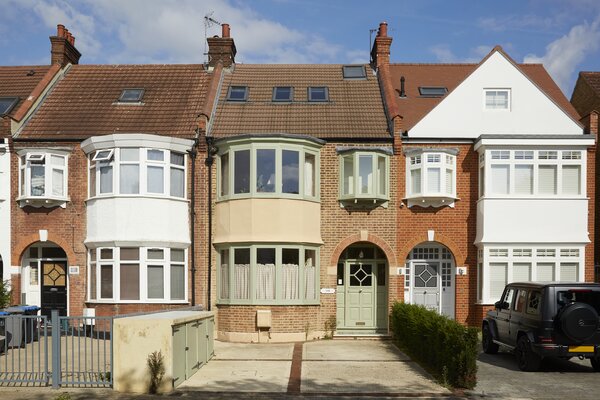 Tucked away in a quiet enclave of North West London, the two-level cottage welcomes guests via a charming arched porch. Several green parks are located within a short walk.