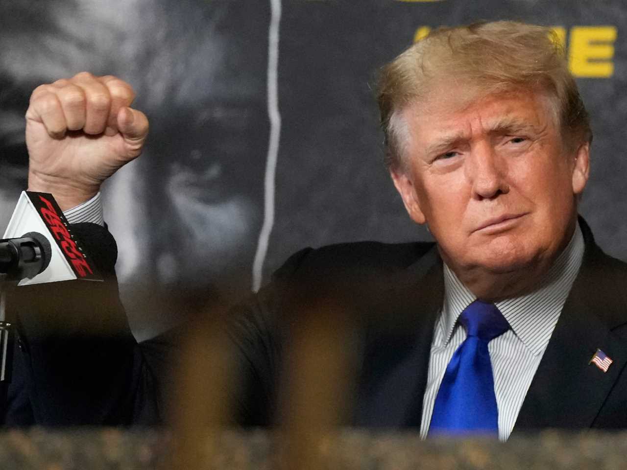 Former President Donald Trump salutes cheering fans as he prepares to provide commentary for a boxing event in Hollywood, Florida, on Sept. 11, 2021.