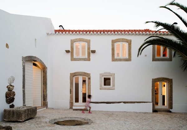 The enclosed courtyard features original stone.