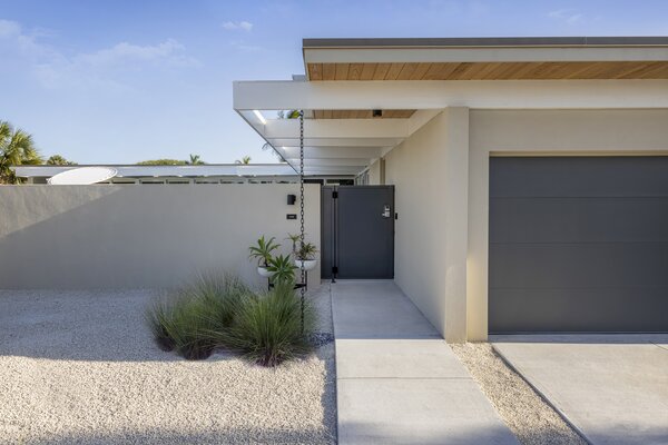 A modest street-facing facade allowed the Brunsons to concentrate their design energy on the L-shaped home's interior and the pool behind the gate.