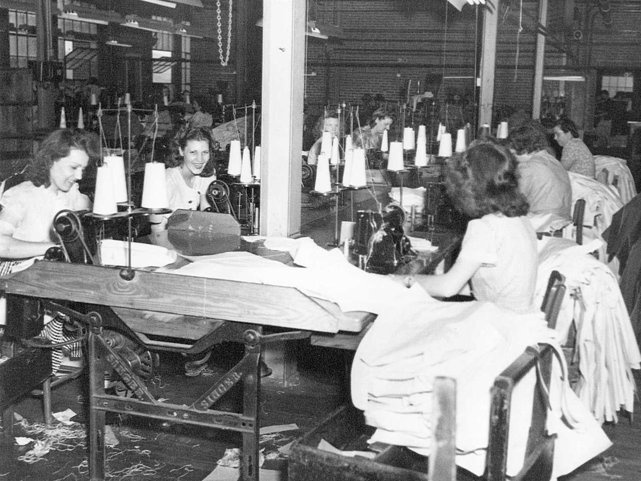 Carhartt factory with workers sitting in two rows sewing clothing