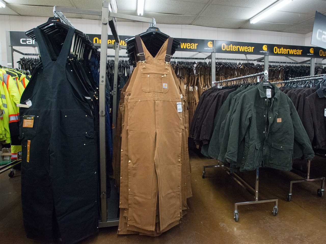 Carhartt Fire Retardant Clothing and other clothing suitable for oil field workers hangs on clothing racks