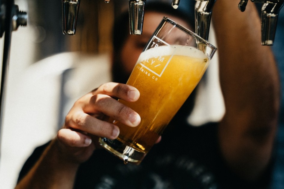 Beer being poured into a glass from a tap