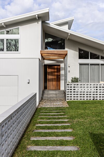 The use of white breeze blocks for the external brickwork at the front directly references classic beach houses found throughout the area.