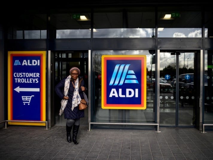 FILE PHOTO: A shopper leaves an Aldi store in London, Britain February 15, 2018. REUTERS/Peter Summers/File Photo 